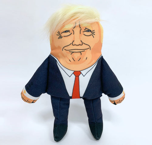 Donald Trump Dog Toy, wearing navy suit with red tie, with recognisable hair style, printed facial features and strangley prange complexion.