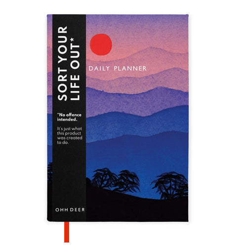 The daily planner has a design in reds, blue and dark purple of the sun rising over a mountainous landscape. It has a paper merchandising strip running down the front which reads “SORT OUT YOUR LIFE, *No offence intended.  Its just what this product was created to do.  288 pages to optimise your day.  Made using sustainable materials”.
