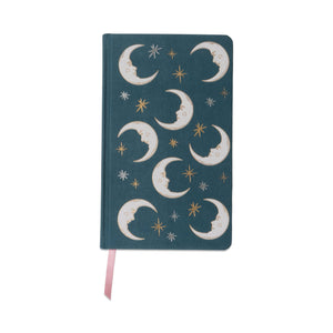 Notebook with moon and star design on a teal background