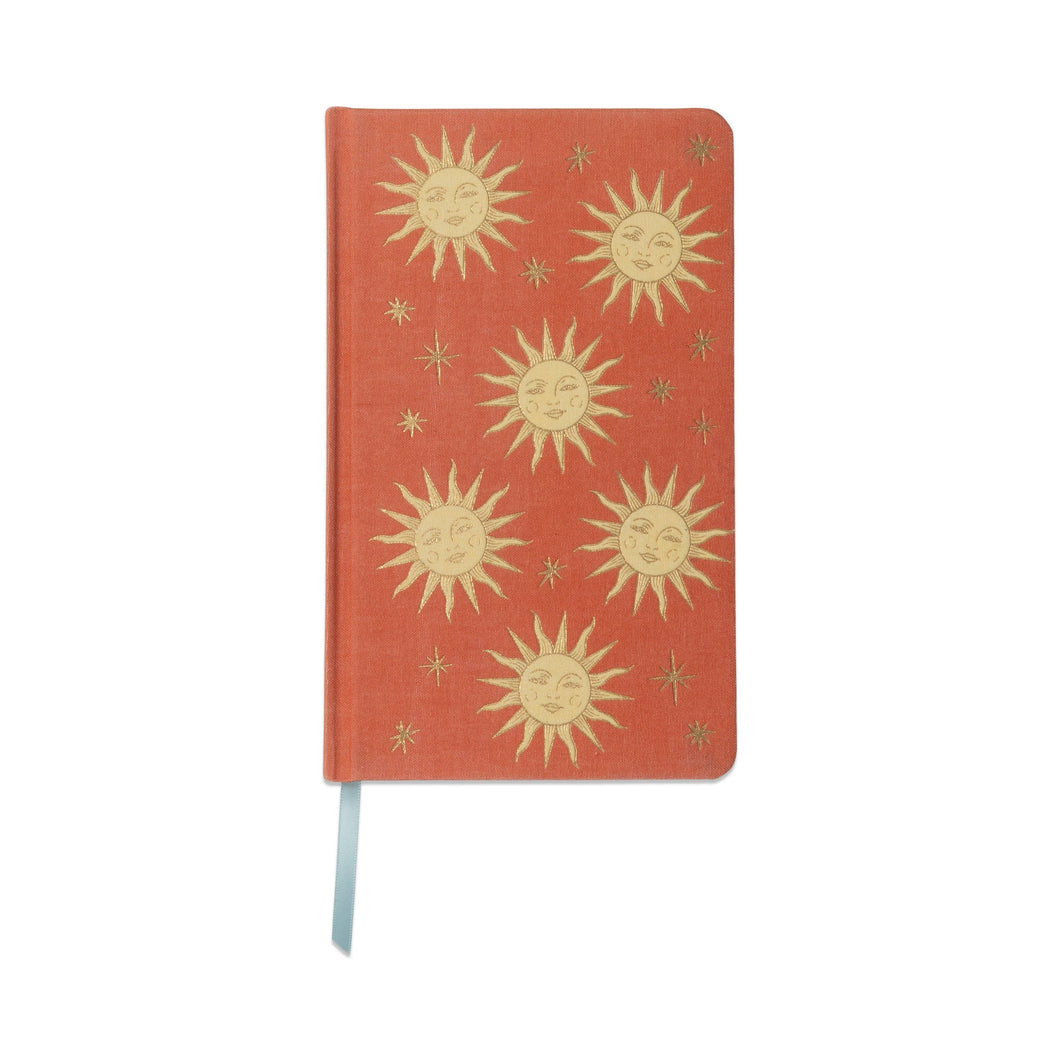 Red notebook with gold sun designs 