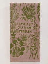 Load image into Gallery viewer, tea towel with a light pink background with green plants and writing in the center that reads &quot;I have a bit of a plant problem&quot;.
