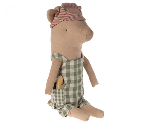 Soft toy pig wearing a striped red and cream cap with his ears sticking out through slits, and wearing green and white gingham overalls.  He has a toy baguette sticking out of his pocket