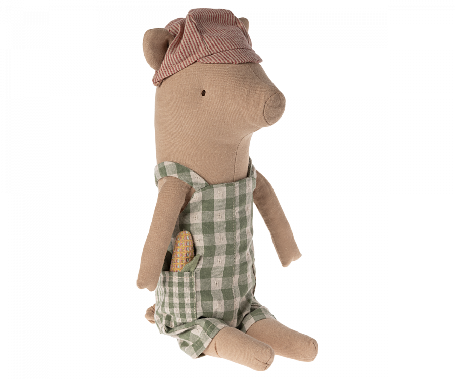 Soft toy pig wearing a striped red and cream cap with his ears sticking out through slits, and wearing green and white gingham overalls.  He has a toy baguette sticking out of his pocket