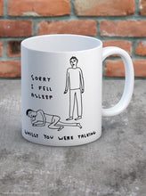 Load image into Gallery viewer, David Shrigley Boxed Mug – Sorry I Fell Asleep | £10.00. White ceramic mug with David Shrigley line drawing of a person asleep at the feet of another with the words “Sorry I fell asleep whilst you were talking”. The perfect gift for fans of humorous, quirky illustration.
