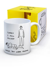 Load image into Gallery viewer, David Shrigley Boxed Mug – Sorry I Fell Asleep | £10.00. White ceramic mug with David Shrigley line drawing of a person asleep at the feet of another with the words “Sorry I fell asleep whilst you were talking”. The perfect gift for fans of humorous, quirky illustration.
