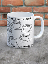 Load image into Gallery viewer, David Shrigley Boxed Mug – The Tea is Alive | £10.00. White ceramic mug with David Shrigley line drawing of mugs with a face within them with the writing “The tea is alive, it will live inside you”. The perfect gift for fans of humorous, quirky illustration and for tea drinkers.
