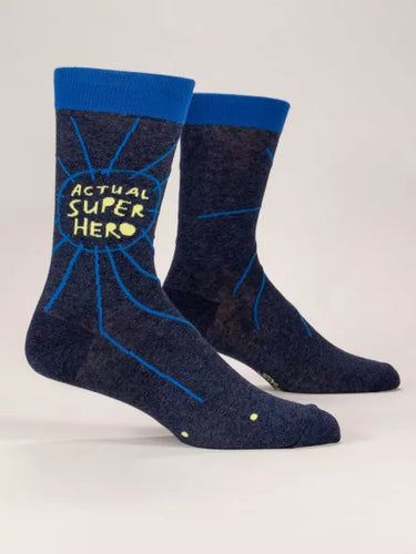Actual Superhero Men’s crew Socks by Blue Q | £11.95. Ethical and sustainable socks with quirky, humorous designs and vibrant colours. Grey and Navy socks with the words “Actual Superhero” in cartoon yellow writing.  