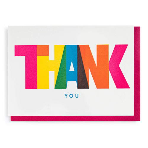 Bright, colourful, striking, thank you card.  The word THANK is printed in bright colours, each letter a differnt one.  the letters and the colours slightly overlap, eg the yellow H and the blue A create a green overlap. underneath in much smaller capitals is the word YOU in bright blue.