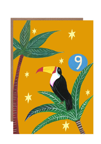 9th birthday card featuring a toucan in a palm tree wit a vibrant mustard background with a blue circle with the number 9 on it.