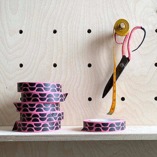 Bright pink paper tape roll, with a design of black alternating semi circles.  Retro looking design.  Fits perfectly on standard sellotape dispenser. 