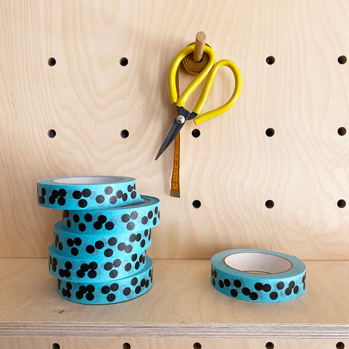 Bright turquoise paper tape with black irregular polka dots. Fits on a standards sellotape dispenser.