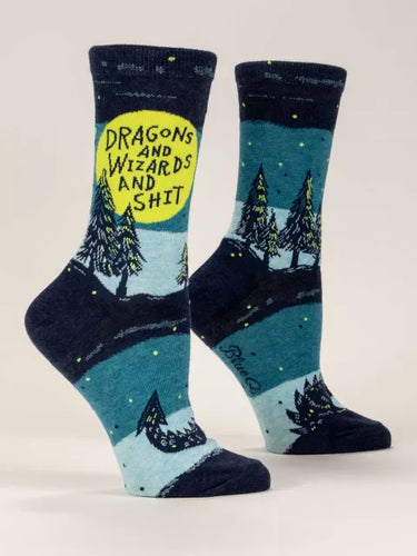Socks with night time landscape and trees and a dragons tail emerging from the ground.  The text “Dragons and Wizards and Shit” is written in capitals in the large full moon.