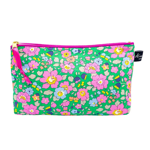 Cosmetic bag in Liberty print Betsy Meadow. Bright green background with pink and blue flowers.