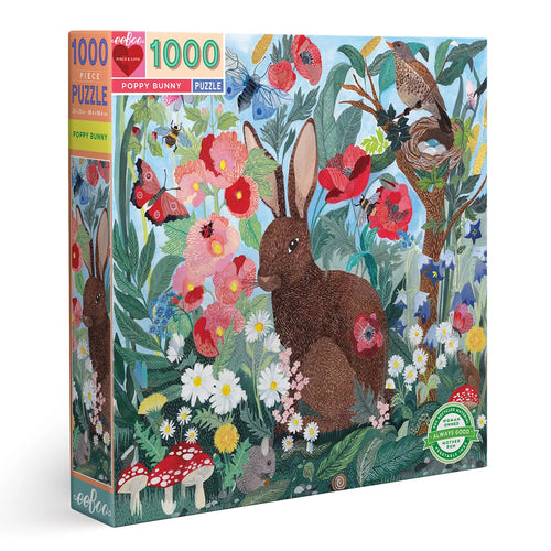 An image of the boxed puzzle.  The brown bunny sits surrounded by poppies and other flowers and mushrooms and a tree with a nesting bird.  A small mouse can also be seen eating a berry. Bbutterflies and bees are flying about.