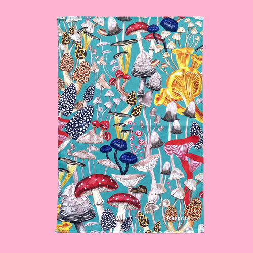 Blue tea towel with a variety of different mushrooms in reds,pinks and blue 