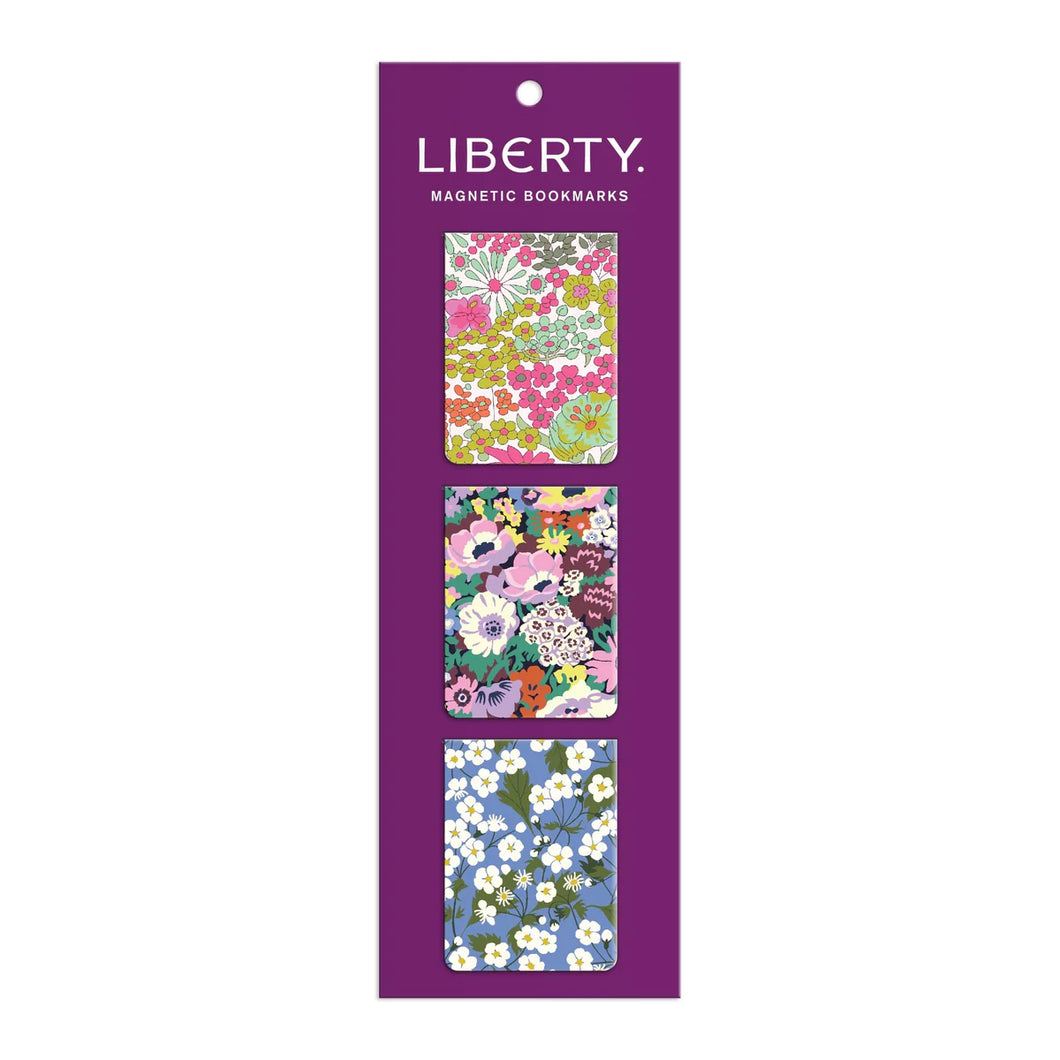 3 floral rectangular magnetic bookmarks in a vertical line on their purple packaging with Liberty Magnetic Bookmarks printed at top.