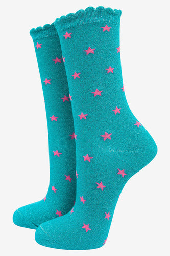 Pair of bright aqua glittery socks with small bright pink stars all over them.  The ankle socks have a scalloped edge at the ankle.