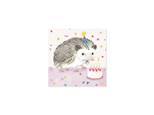 The front of the pop up card featuring a hedgehog wearing a sparkly party hat with a birthday cake with candles and raspberries on top