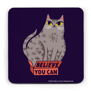 Black background coaster with curved corners.  It has an illustration of a large tabby cat sitting in a small red box, which has the lettering "BELiEVE YOU CAN" on it.