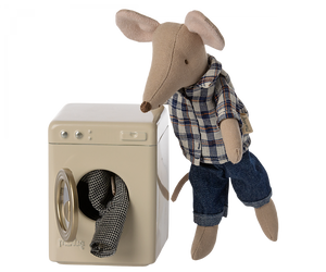 washing machine can be seen with a maileg toy mouse and some maileg toy mouse clotehs sticking out of the washing machine 