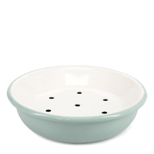 Load image into Gallery viewer, A round enamel soap dish with a light sage green exterior and a white interior, featuring six small drainage holes on the bottom, set against a plain white background.
