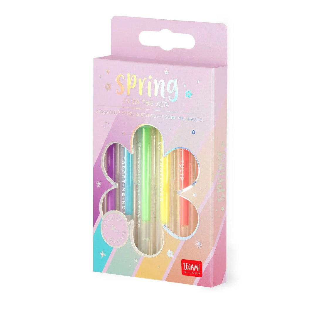 6 pastel gel pens, one pink, one orange, one yellow, one green, one blue, and one purple. They are held in a purple cardboard box, with a cut out in the shape of a flower, allowing you to see the pens.