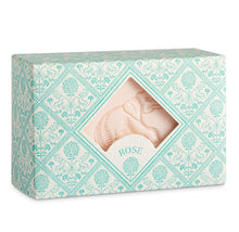 Load image into Gallery viewer, the packaging of the box has a pale blue and white, tile design of eleohants and flowers.  There is a centrail diamond shape cut out through which the pale pink soap with an embossed elephant design can be seen
