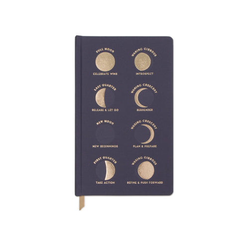 Notebook with moon and star design on a teal background