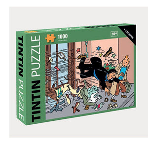 1000 piece Tintin puzzle in a green box with a picture displaying the image of the jigsaw. The image shows captain Haddock falling out of a revolving door, with many o ox ject flying about. Tintin is stood observing the chaos.