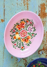 Load image into Gallery viewer, Decorative shallow oval pink enamel bowl with floral design on a rustic wooden surface
