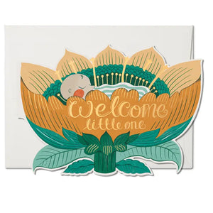 New baby die cutcard featuring a sleeping, rosy cheeked, baby nestled in a flower with gold lettering "Welcome Little One".  Illustrated by Melissa Castrillon for Red Cap Cards, USA.