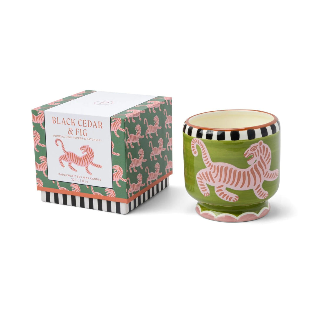 ceramic candle with green background and naive tiger design.  Box has the same design on repeat all over.