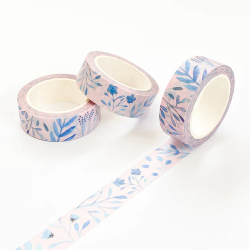 picture shows the tape slightly unravelled, showing the watercolour design of a variety of blue leaves and some flowers on a pink background.
