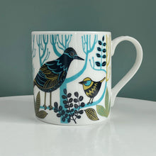 Load image into Gallery viewer, Beautifuilly illustrated birds in black, blue and mustard yellow sitting on light blue branches and surrounded by leaves.
