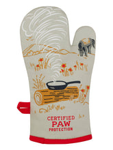 Load image into Gallery viewer, The reverse of the oven mitt has the words “CertifiedPaw Protection” at the bottom and an illustration of a steaming pan on a log and ahorse grazing in the background
