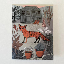 Load image into Gallery viewer, Beautiful hand illustrated fox standing in a garden with two cubs behind her. There is a garden shed in the background anf lots of beautiful potted plants in the foreground. 
