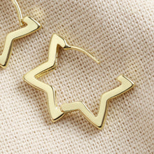 Load image into Gallery viewer, Gold Star Hoop Earrings by Lisa Angel | £18.00. These hoop star-shaped earrings are wonderful for adding a golden finishing touch to your look. Made from 18ct gold plated brass , these earrings open by pulling them gently apart at the top, opening them via the hinge at the bottom to reveal the 18ct gold sterling silver posts.
