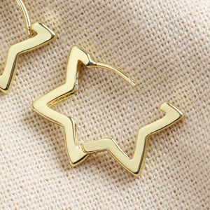 Gold Star Hoop Earrings by Lisa Angel | £18.00. These hoop star-shaped earrings are wonderful for adding a golden finishing touch to your look. Made from 18ct gold plated brass , these earrings open by pulling them gently apart at the top, opening them via the hinge at the bottom to reveal the 18ct gold sterling silver posts.