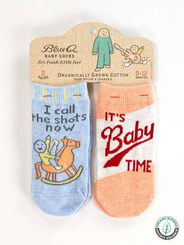 2 pairs of baby socks on cardboard header card.  one has a blue background and a cartoon of a baby on a rocking horse witht hte words 