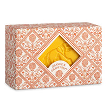 Load image into Gallery viewer, the packaging of the soap has a, soft pink,  tile design with elephants and flowers.  in the centre of the box is a diamons shape cut out through which the yellow soap can be seen with its embossesd elephant design
