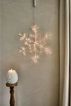 Load image into Gallery viewer, white fairy lights in a snowflake shaped hanging ornament 
