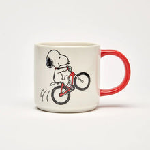 Load image into Gallery viewer, The front of the mug features an illustration of snoopy riding a bicycle
