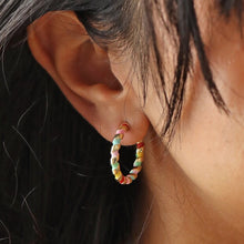 Load image into Gallery viewer, Rainbow Enamel Twist Hoop Earrings in Gold by Lisa Angel | £20.00. A pair of gold hoop earrings with rainbow enamel twists, designed by Lisa Angel. The hoops feature vibrant colours in a twisted pattern, adding a playful and colourful touch to any outfit.
