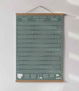 grey green tide chart can be seen hanging on the wall in an oak wood poster hanger