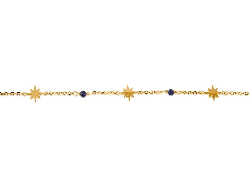 Gold bracelet with star shaped charms and small blue beads on white background