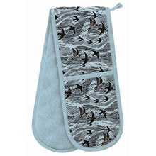 Load image into Gallery viewer, light blue background and reverse.  The front of the double oven glove has an over all design of sea waves and swallows in black.
