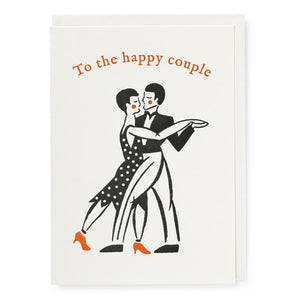 a black and white print of a dancing couple with red details of rosy cheeks and the woman's red shoes.  Above them in red lettering it reads "To the happy couple"