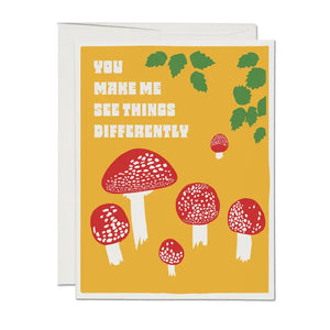 This card reads "you make me see things differently" and features an illustration of fly agaric maushrooms by Lonely Palm Ranch for Red Cap Cards. Suitable as a  valentine's card, or friendship card