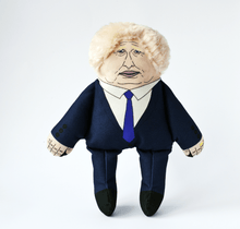 Load image into Gallery viewer, Squeaking Dog toy doll of Boris Johnson wearing a navy suit and tie, with recognsably printed face and mop of white blobs hair.
