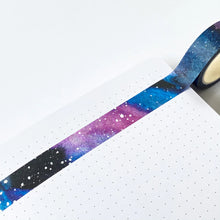 Load image into Gallery viewer, this photo shows the washi tape stuck accross a page showing the colours from black, purples and blues making up the backgpround of the galaxy with little white dots (planets and stars) dotted over.
